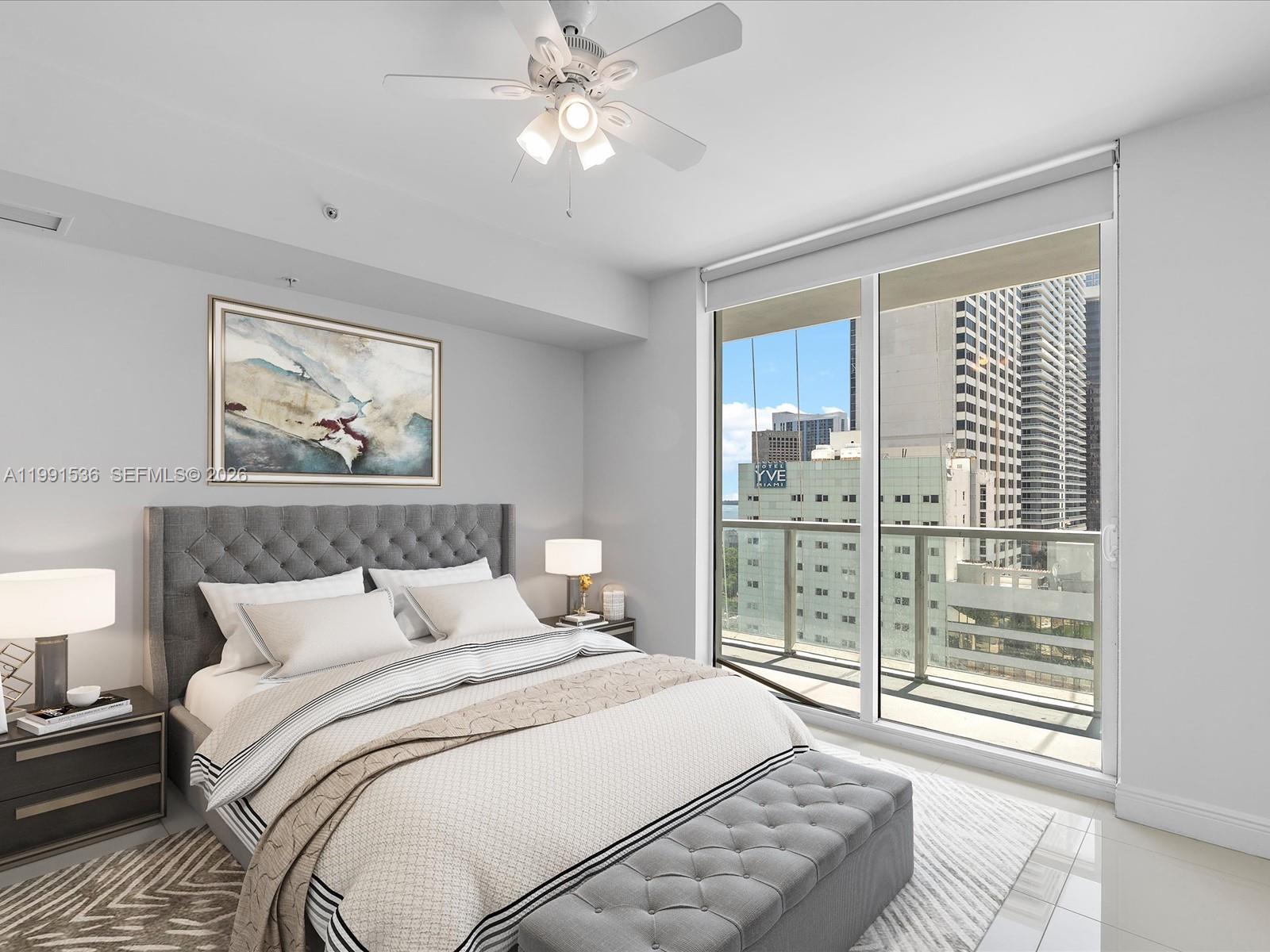 244 Biscayne Boulevard, Unit 1605 Miami, FL 33132 - Photo 20 of 46 a bedroom with a large bed and a window
