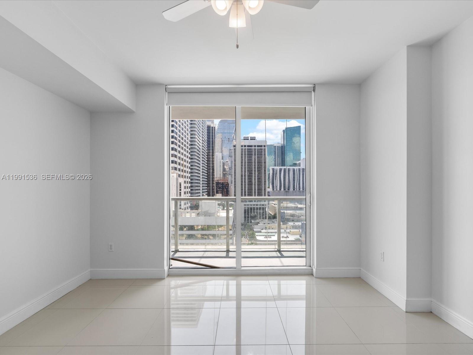 244 Biscayne Boulevard, Unit 1605 Miami, FL 33132 - Photo 21 of 46 a view of empty room with wooden floor and fan