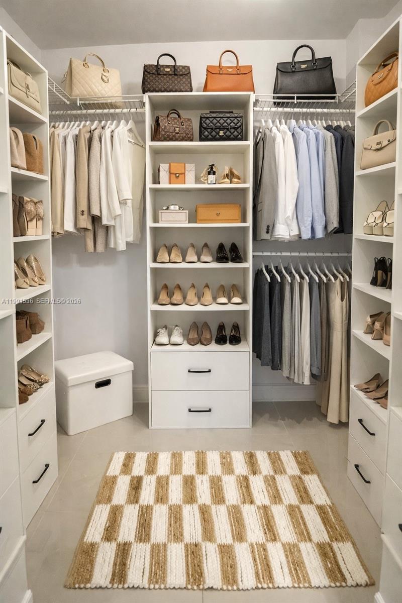 244 Biscayne Boulevard, Unit 1605 Miami, FL 33132 - Photo 27 of 46 a view of walk in closet with clothes and shoes
