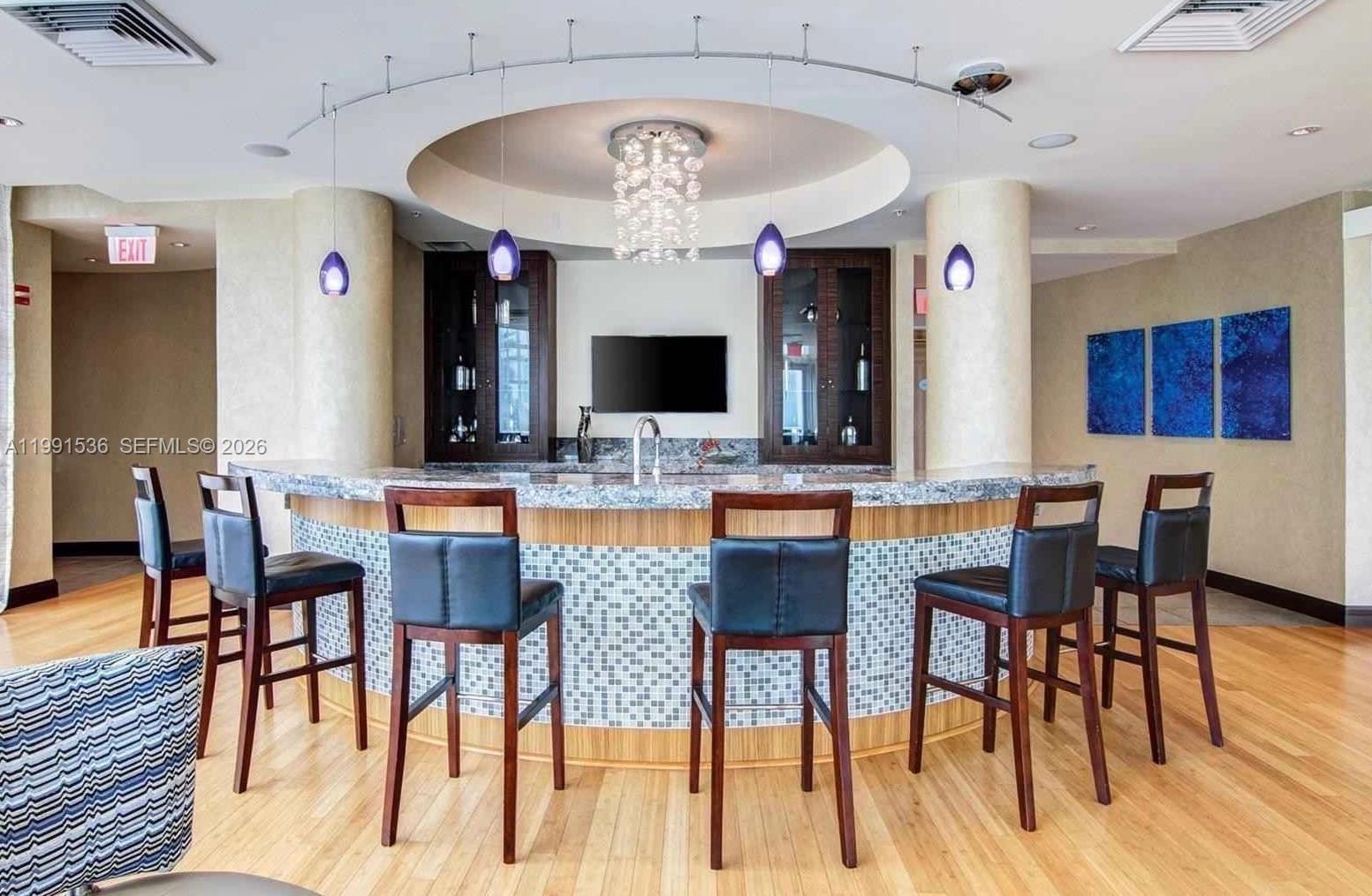 244 Biscayne Boulevard, Unit 1605 Miami, FL 33132 - Photo 41 of 46 a view of a dining room with furniture and wooden floor