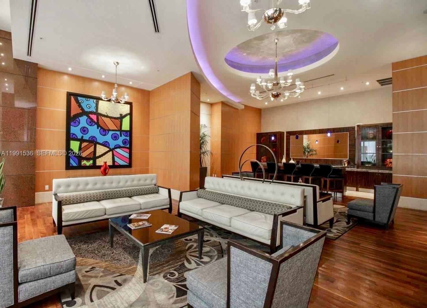 244 Biscayne Boulevard, Unit 1605 Miami, FL 33132 - Photo 45 of 46 a living room with furniture and a flat screen tv