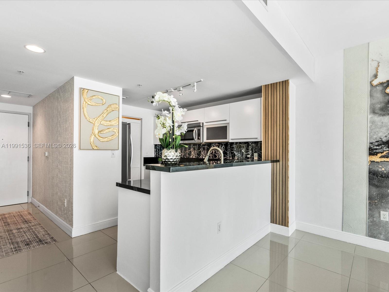 244 Biscayne Boulevard, Unit 1605 Miami, FL 33132 - Photo 8 of 46 a view of kitchen and windows