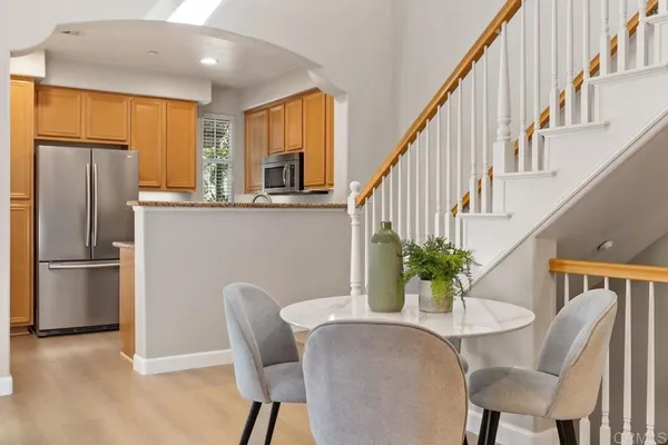 a dining room with furniture potted plants and wooden floor