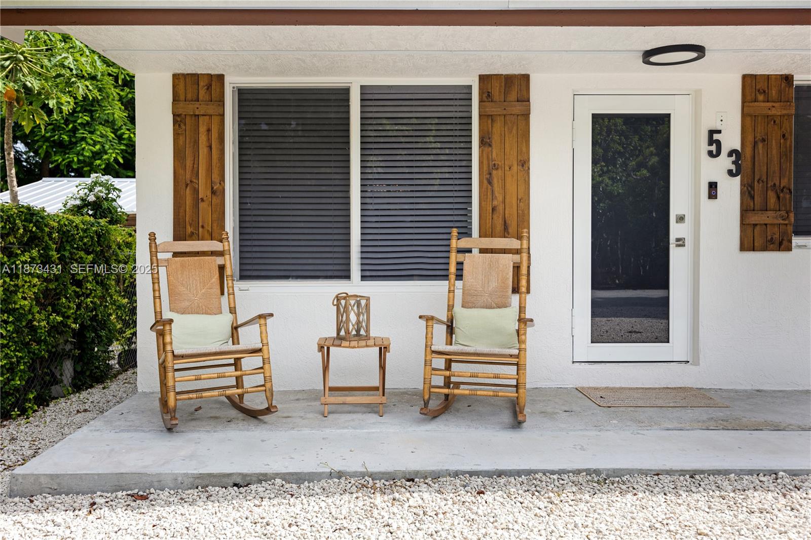 53 Bonefish Avenue Key Largo, FL 33037 - Photo 12 of 25 a backyard of a house with sofas table and chairs