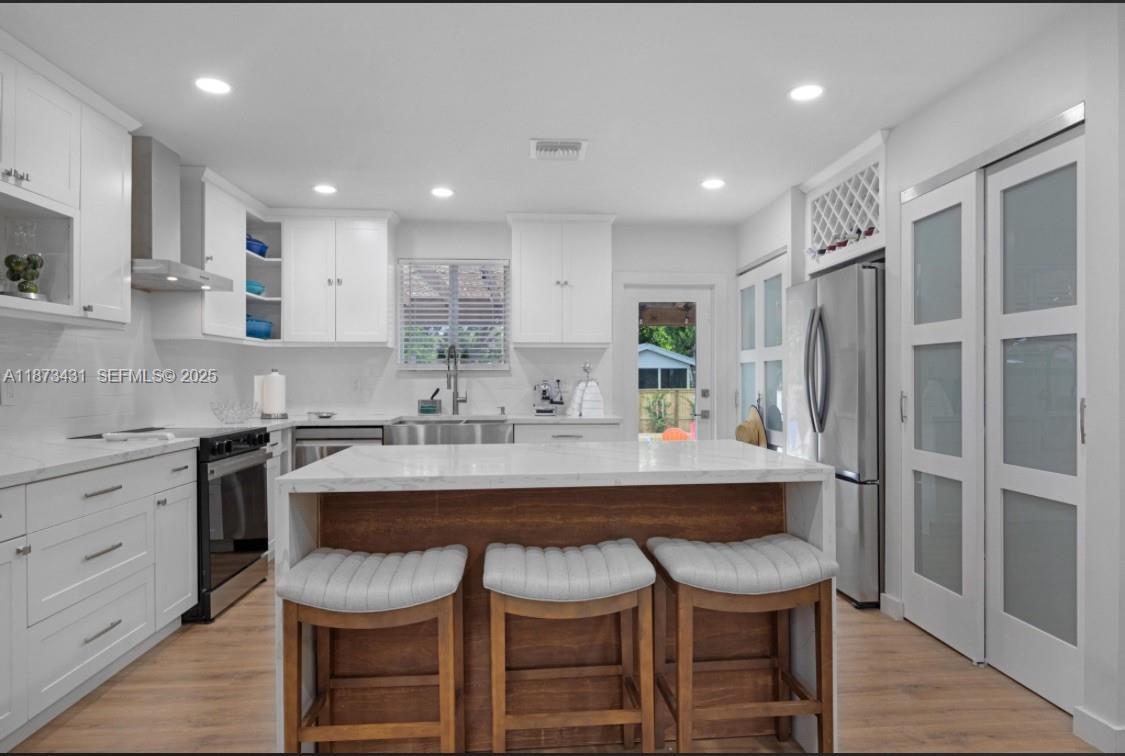 53 Bonefish Avenue Key Largo, FL 33037 - Photo 17 of 25 a kitchen with stainless steel appliances granite countertop a sink and a refrigerator