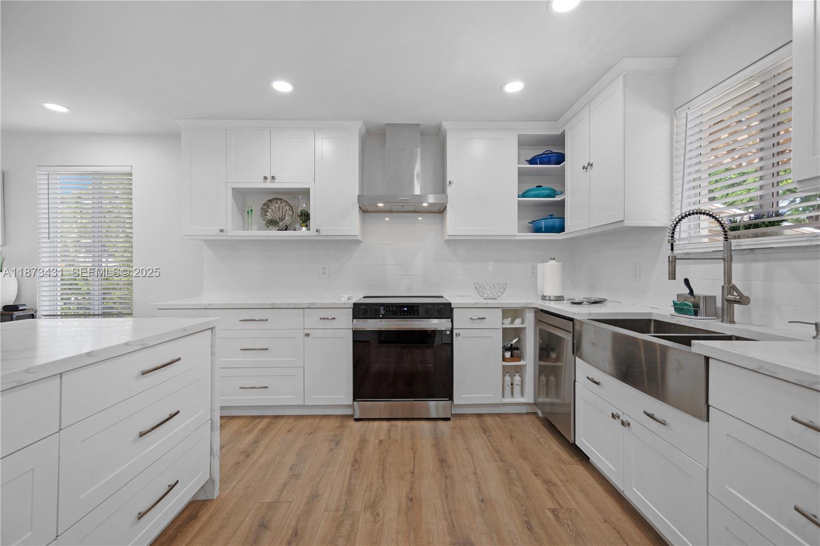 53 Bonefish Avenue Key Largo, FL 33037 - Photo 18 of 25 a kitchen with granite countertop white cabinets and stainless steel appliances