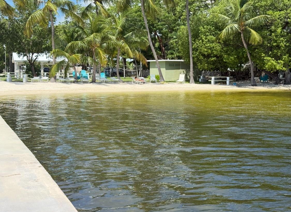 53 Bonefish Avenue Key Largo, FL 33037 - Photo 4 of 25 a view of a swimming pool with an outdoor space and seating area