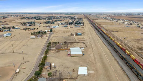 an aerial view of residential houses with outdoor space