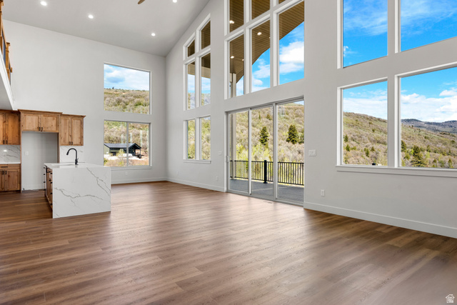 1159 North Broad Hollow Road Garden City, UT 84028 - Photo 2 of 55 Spacious open-concept living area featuring high ceilings and expansive windows