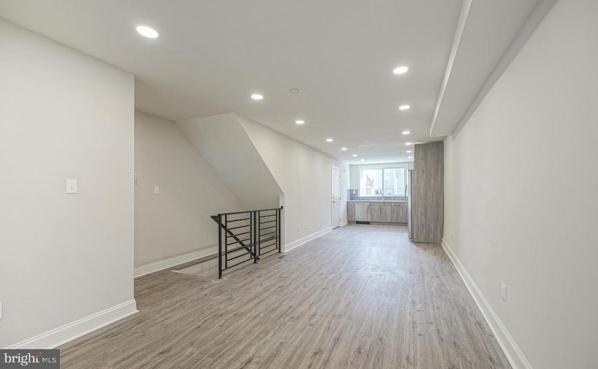 1702 North Gratz Street, Unit 1 Philadelphia, PA 19121 - Photo 3 of 12 a view of a room with wooden floor and windows