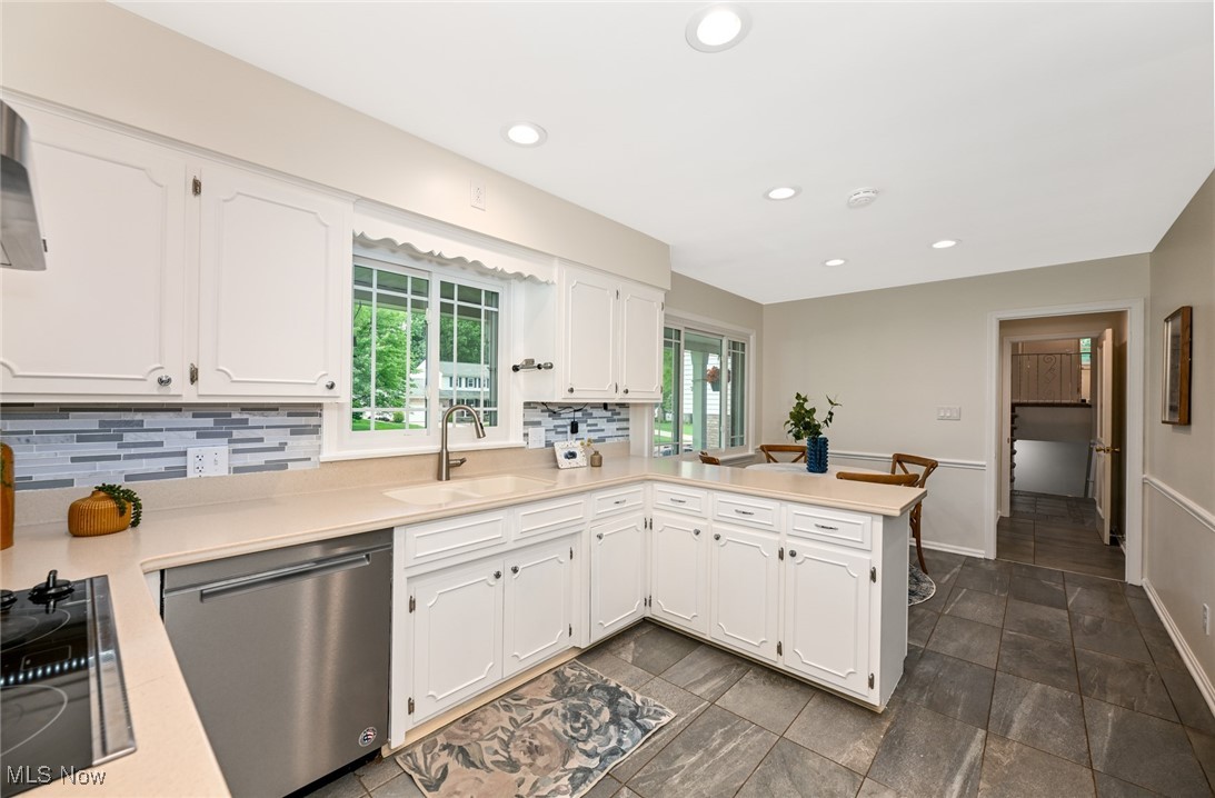 2015 Burlington Road Akron, OH 44313 - Photo 12 of 50 Kitchen with dishwasher, a sink, black electric cooktop, decorative backsplash, and recessed lighting