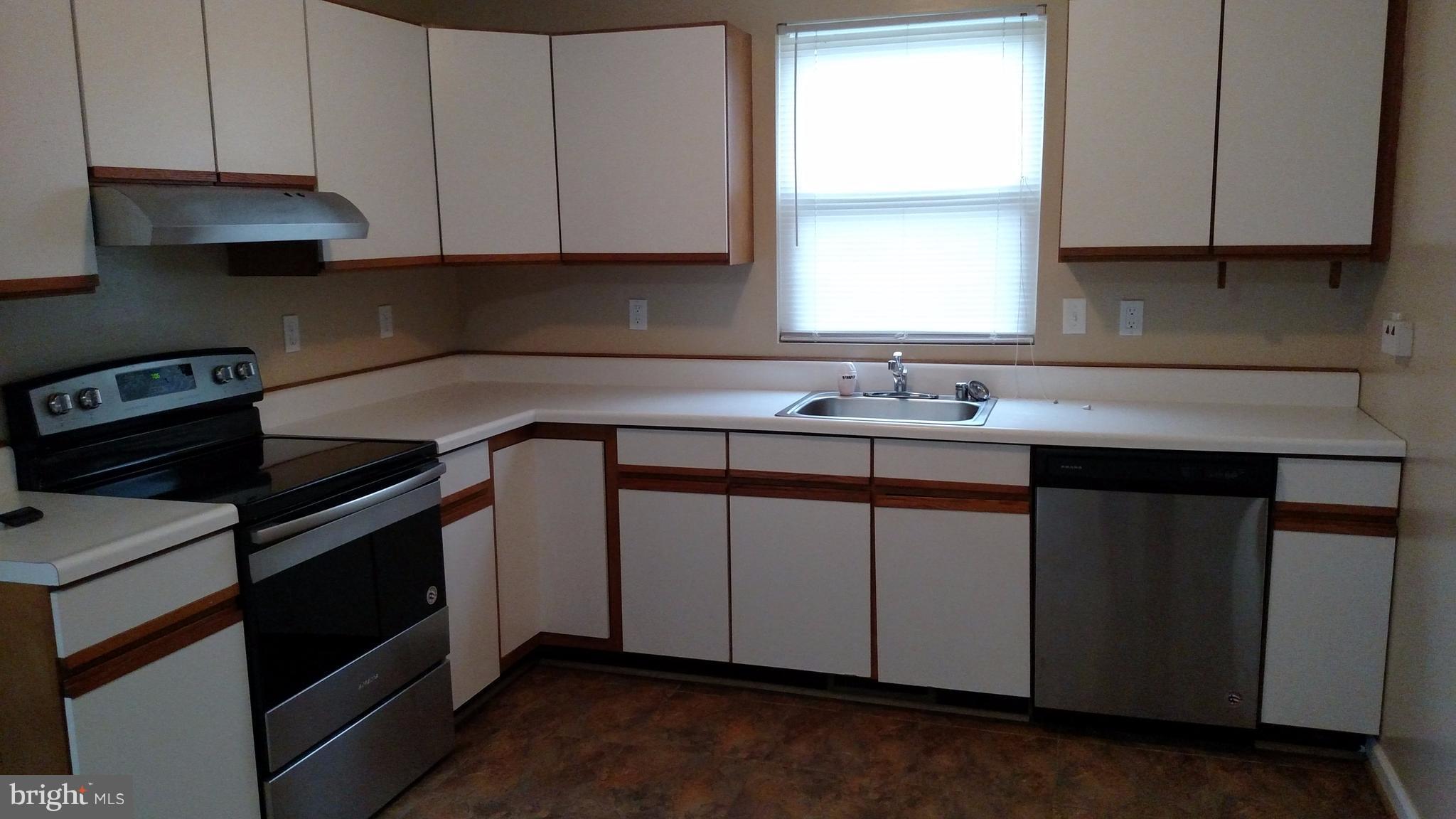 93 Griffith Way Owings, MD 20736 - Photo 3 of 22 a kitchen with a sink stove and cabinets