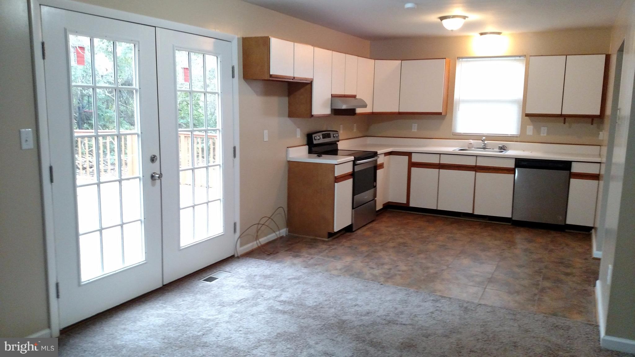 93 Griffith Way Owings, MD 20736 - Photo 7 of 22 a kitchen with a refrigerator stove top oven and sink