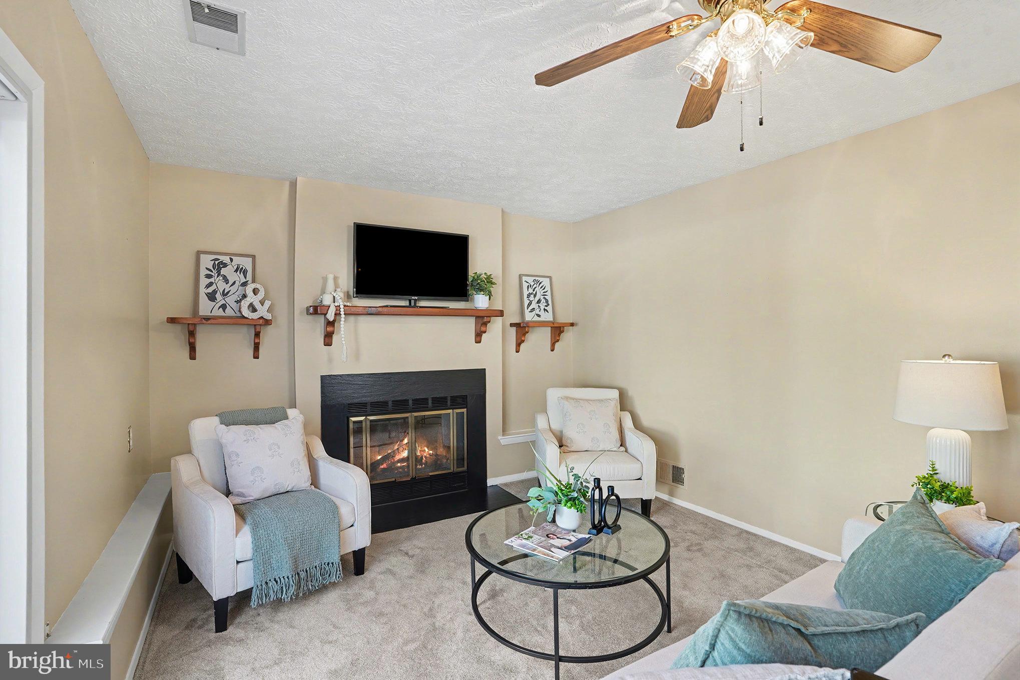 7114 Oliver Beach Road Baltimore, MD 21220 - Photo 14 of 49 a living room with furniture fireplace and a flat screen tv