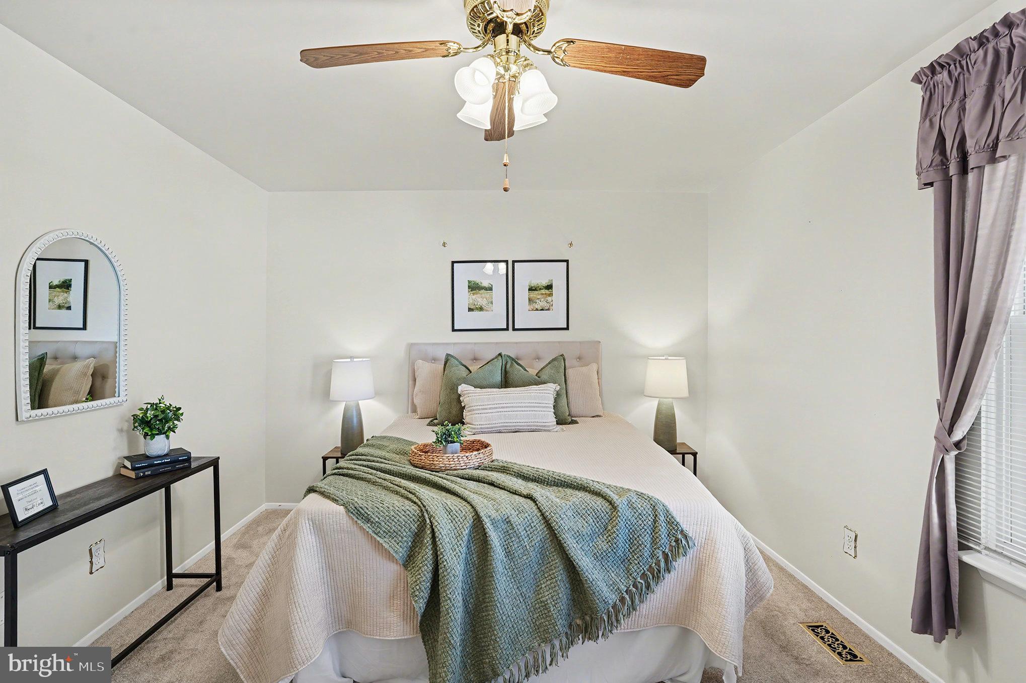 7114 Oliver Beach Road Baltimore, MD 21220 - Photo 19 of 49 a bedroom with a large bed and a chandelier