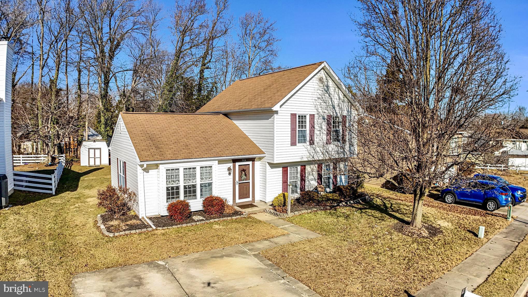 7114 Oliver Beach Road Baltimore, MD 21220 - Photo 5 of 49 a view of a white house with a yard covered in snow