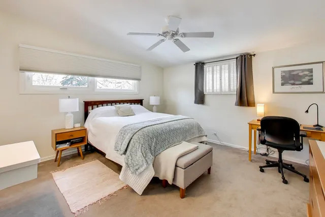 a bedroom with a bed a desk and chair