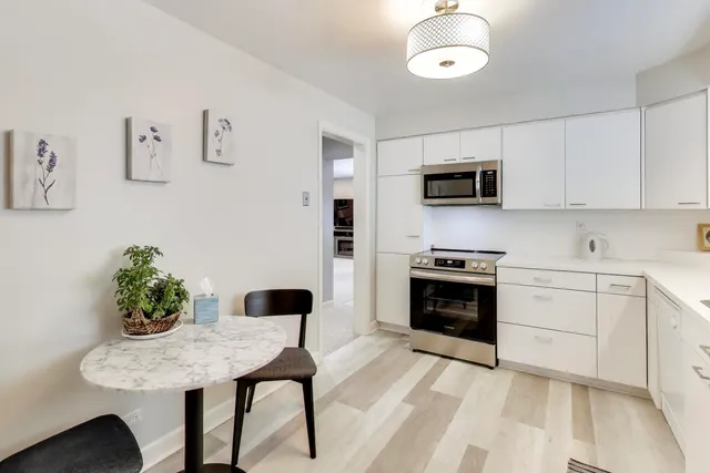 a kitchen with stainless steel appliances kitchen island granite countertop a stove a sink and a microwave