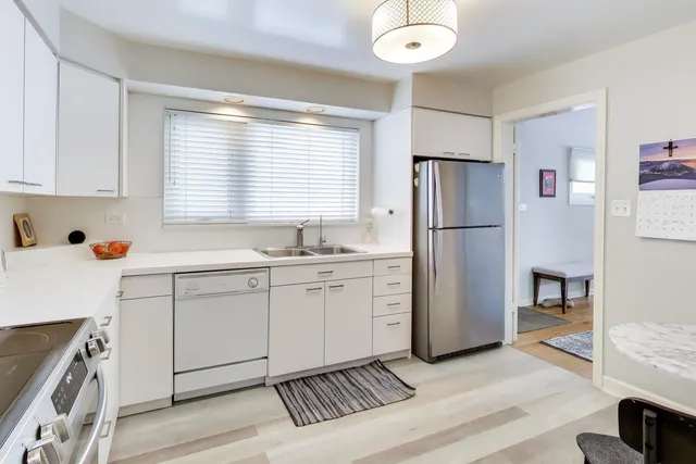 a kitchen with a refrigerator and a sink