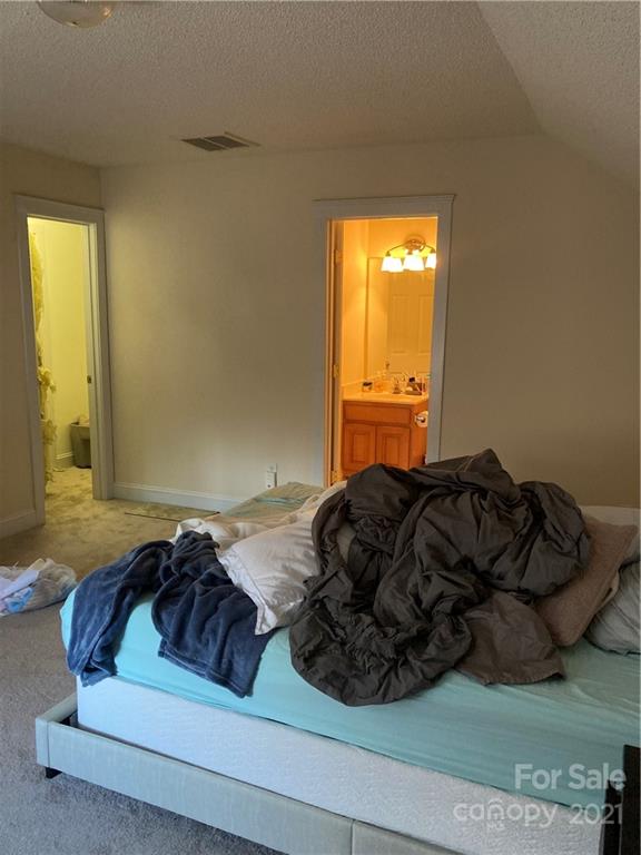 13824 Hastings Farm Road Huntersville, NC 28078 - Photo 13 of 14 a bed sitting in a bedroom next to a window