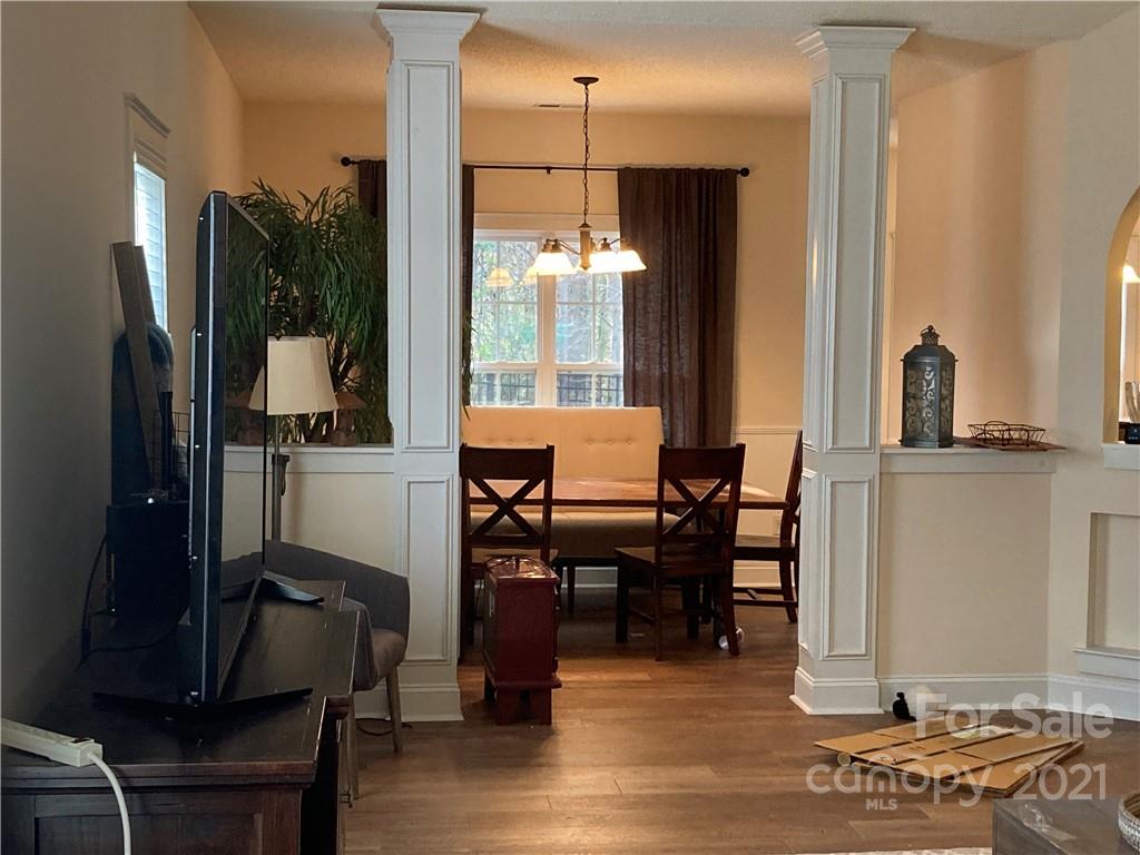 13824 Hastings Farm Road Huntersville, NC 28078 - Photo 4 of 14 a view of a dining room with furniture window and wooden floor