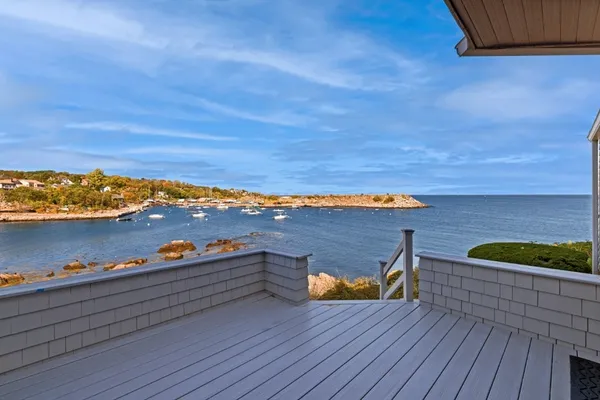 a view of a terrace with wooden floor and a lake view