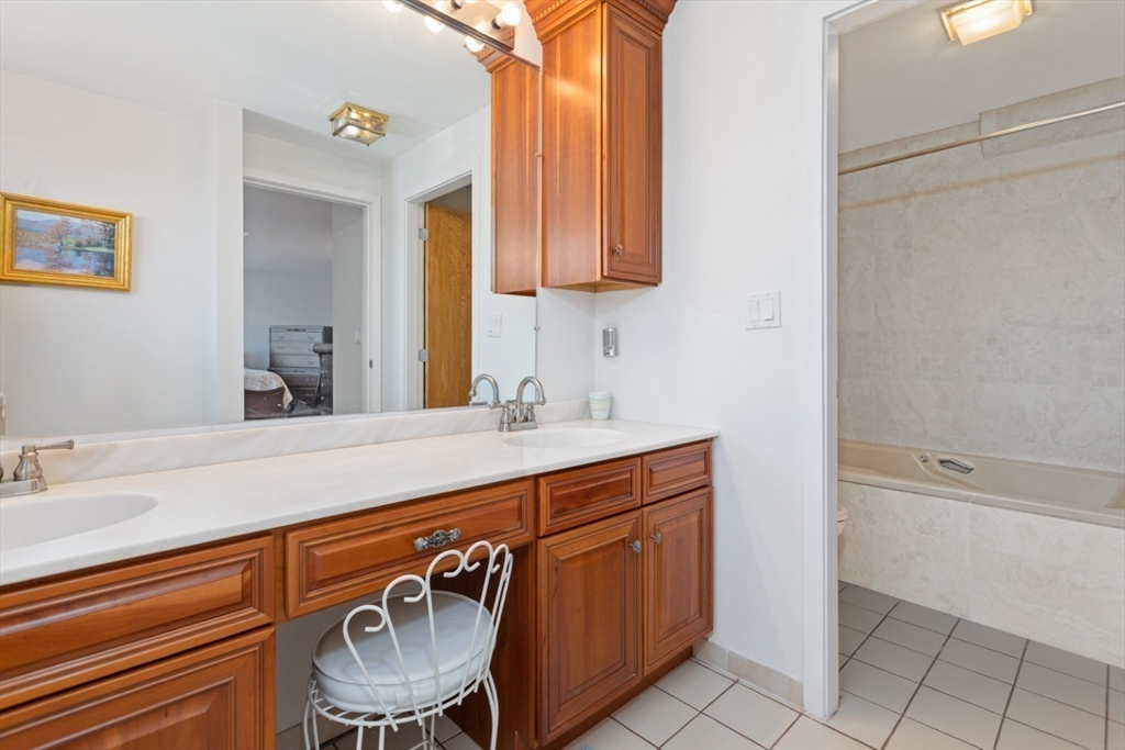 13 Rowe Point, Unit 13 Rockport, MA 01966 - Photo 12 of 27 a bathroom with a sink a vanity and a mirror