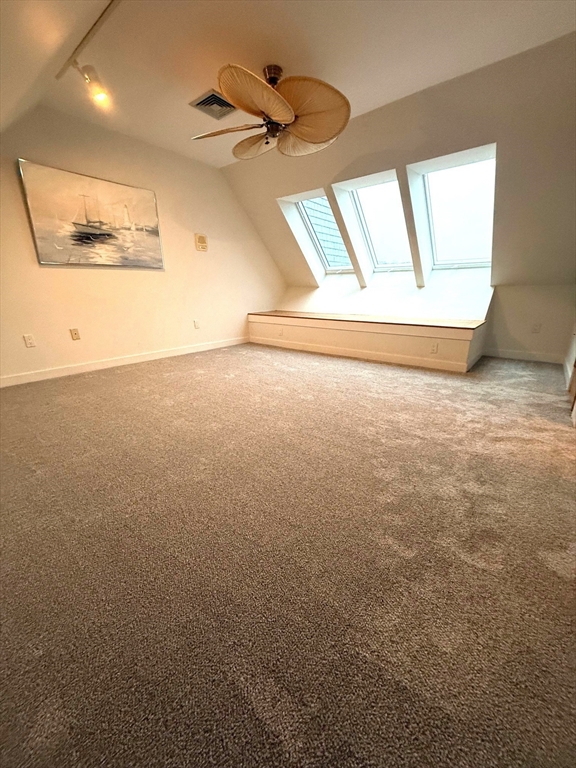 13 Rowe Point, Unit 13 Rockport, MA 01966 - Photo 15 of 27 en empty room with windows and ceiling fan