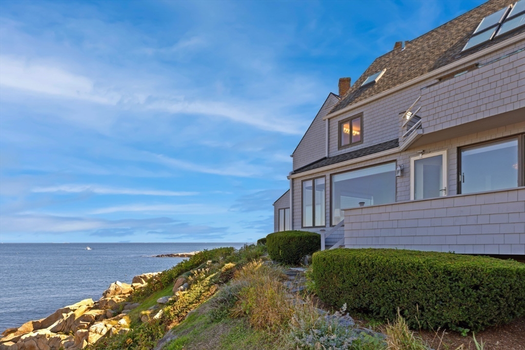 13 Rowe Point, Unit 13 Rockport, MA 01966 - Photo 18 of 27 a view of a brick house with a yard