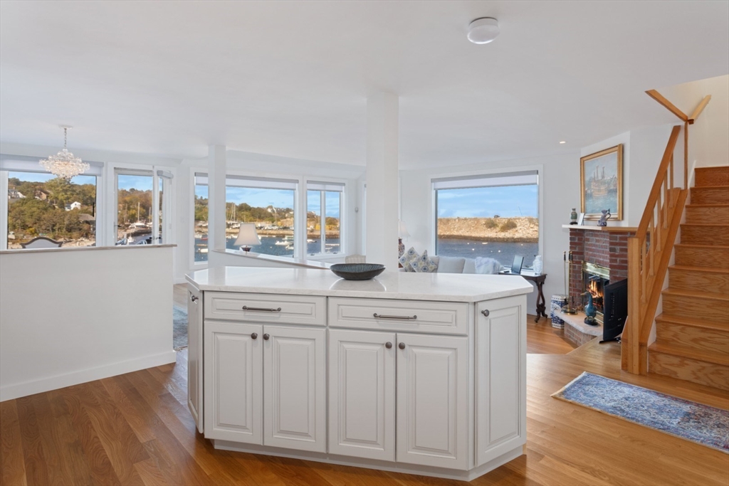 13 Rowe Point, Unit 13 Rockport, MA 01966 - Photo 4 of 27 a kitchen with cabinets and wooden floor