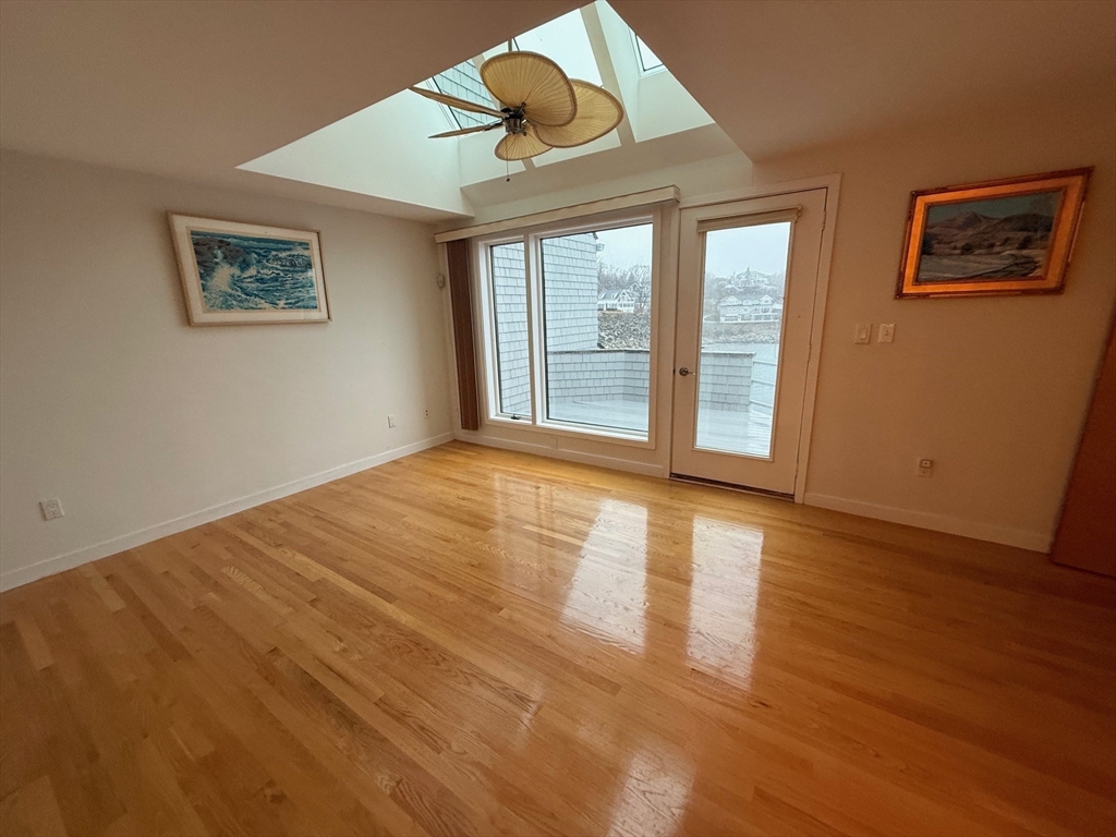 13 Rowe Point, Unit 13 Rockport, MA 01966 - Photo 9 of 27 a view of an empty room with wooden floor and a window