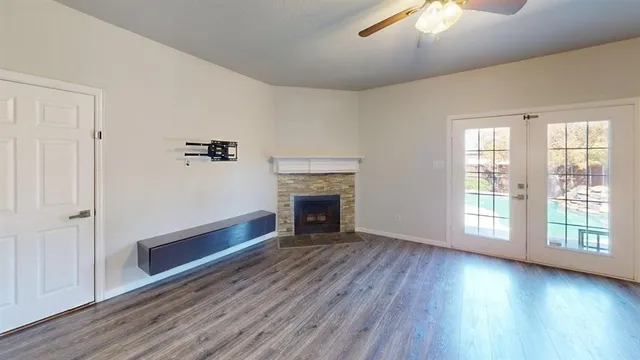 wooden floor fireplace and natural light in room