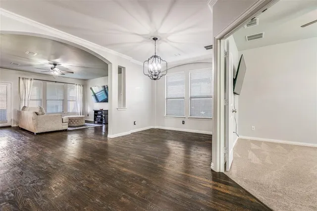 a view of a livingroom with furniture wooden floor and windows
