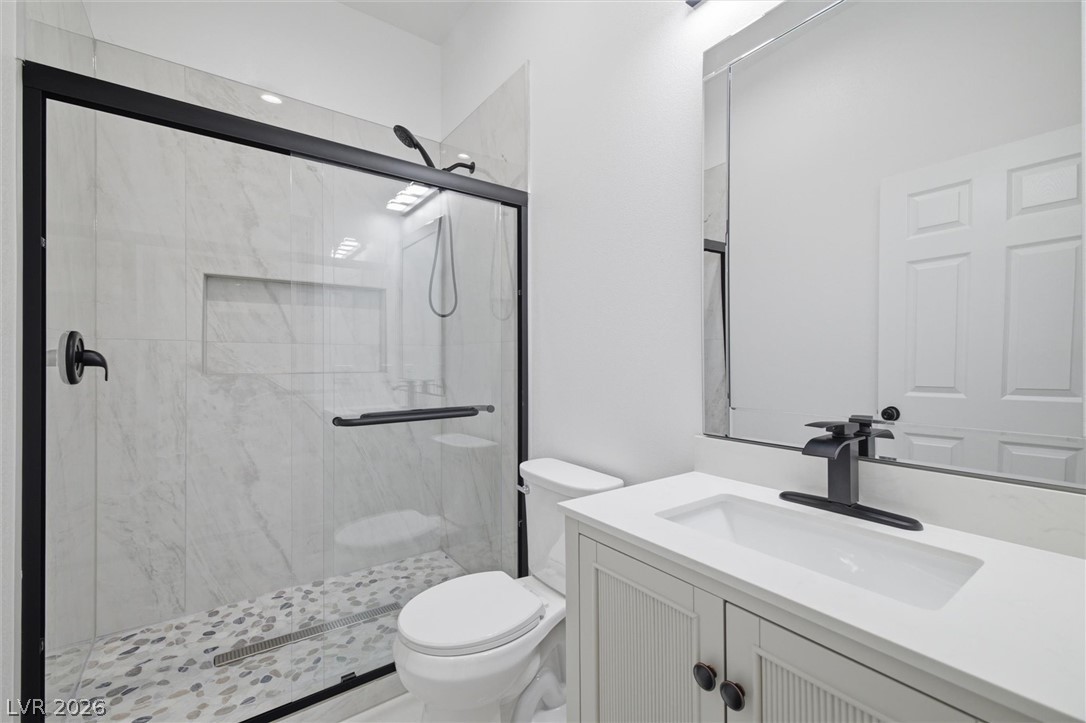 1061 Factory Road Pahrump, NV 89048 - Photo 20 of 41 A sleek, contemporary bathroom with a glass-enclosed shower and modern vanity.