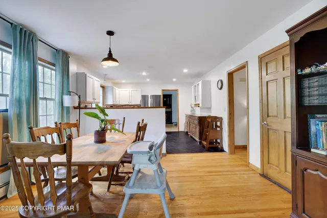 a kitchen with stainless steel appliances granite countertop a sink and a wooden floors