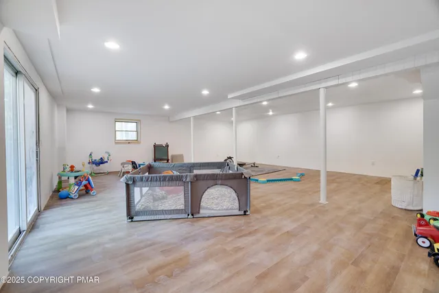 a view of a yard in front of a house with a large tree