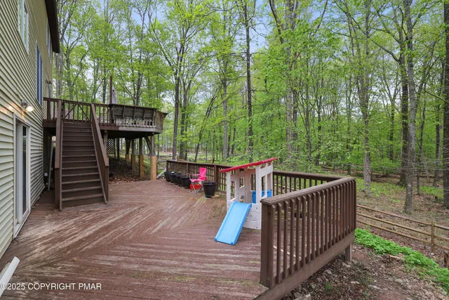 a backyard of a house with barbeque oven table and chairs