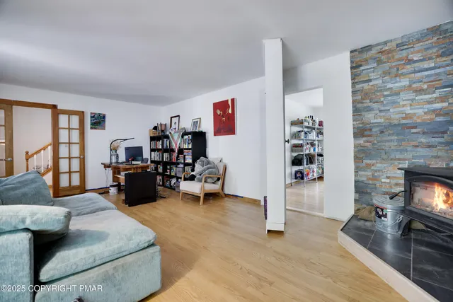 a large kitchen with dining room and wooden floor