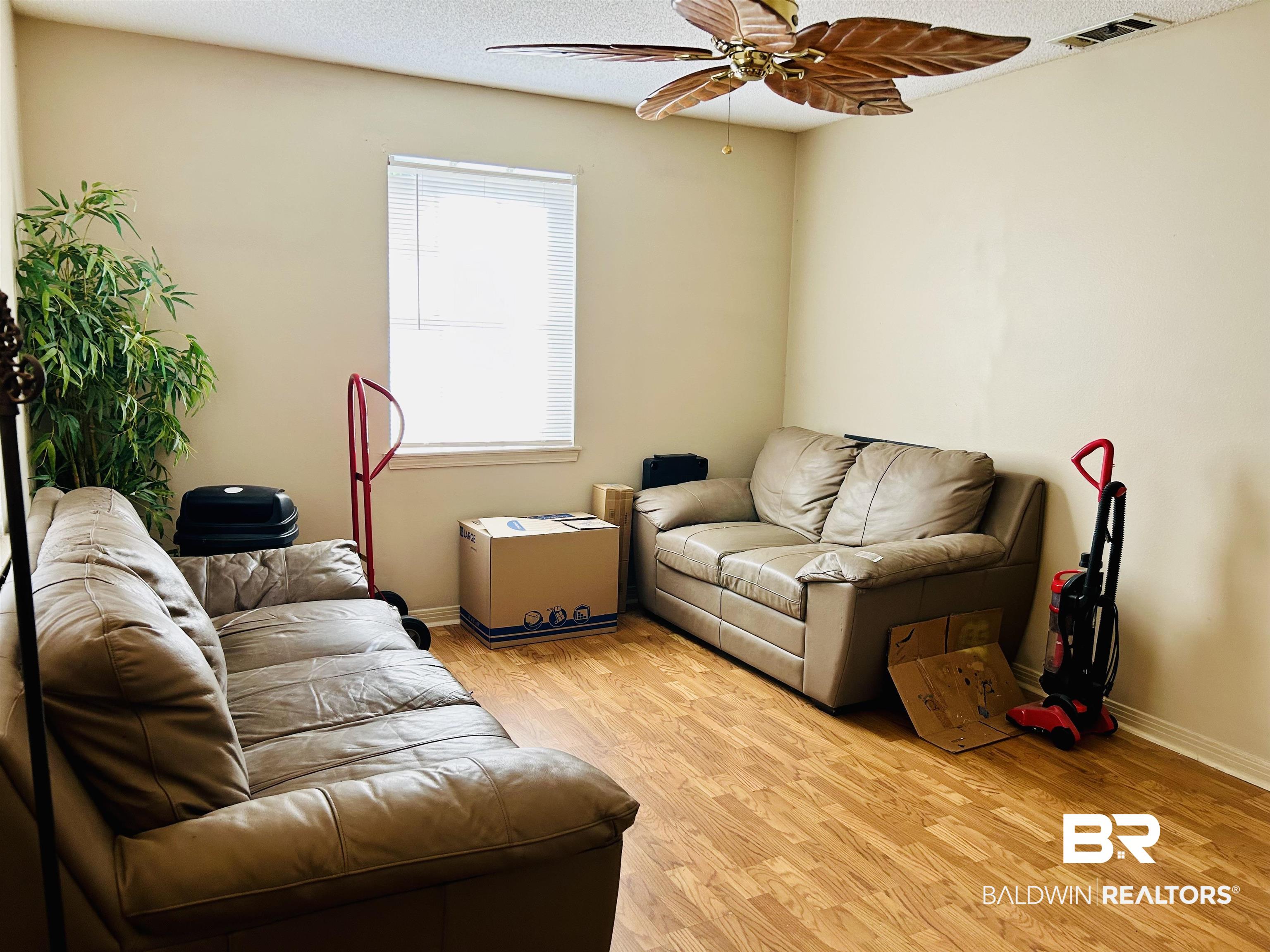 5925 Dixie Lane Mobile, AL 36693 - Photo 2 of 19 Living room with ceiling fan, a textured ceiling, and light hardwood / wood-style floors