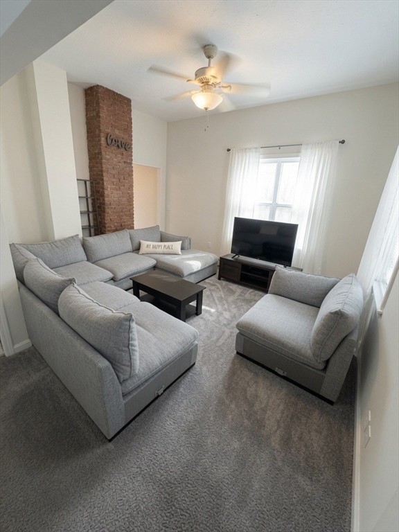 37 Madison Street, Unit 37 Malden, MA 02148 - Photo 8 of 10 a living room with furniture and a large window