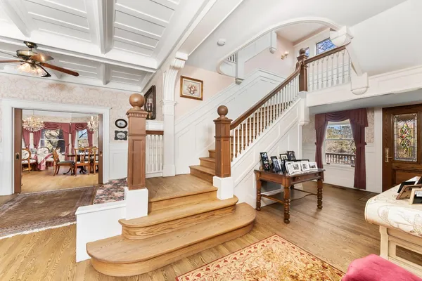 a view of a dining room with furniture wooden floor and chandelier