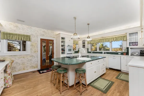 a view of a porch with wooden floor and windows
