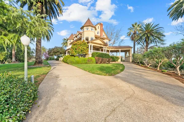 a living room with furniture pool table and a chandelier