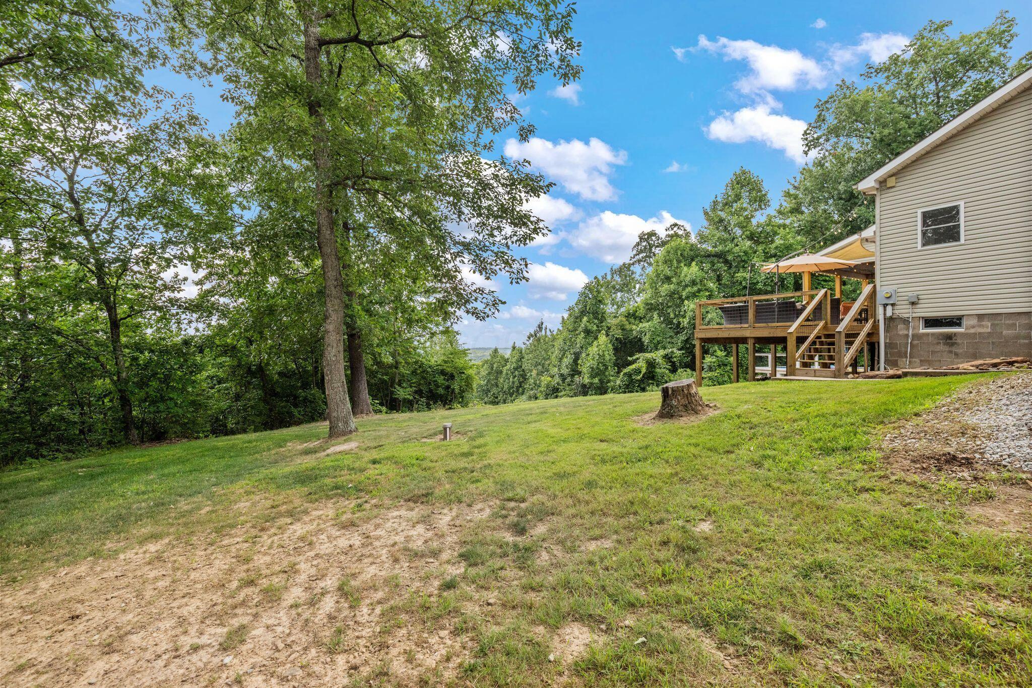10446 Rich Hollow Road Southwest Lancaster, OH 43130 - Photo 75 of 83 Expansive grassy yard with mature trees and a multi-level wood deck