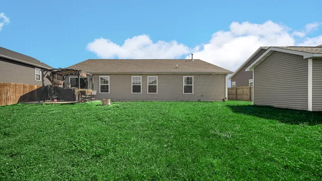 a view of a house with a backyard