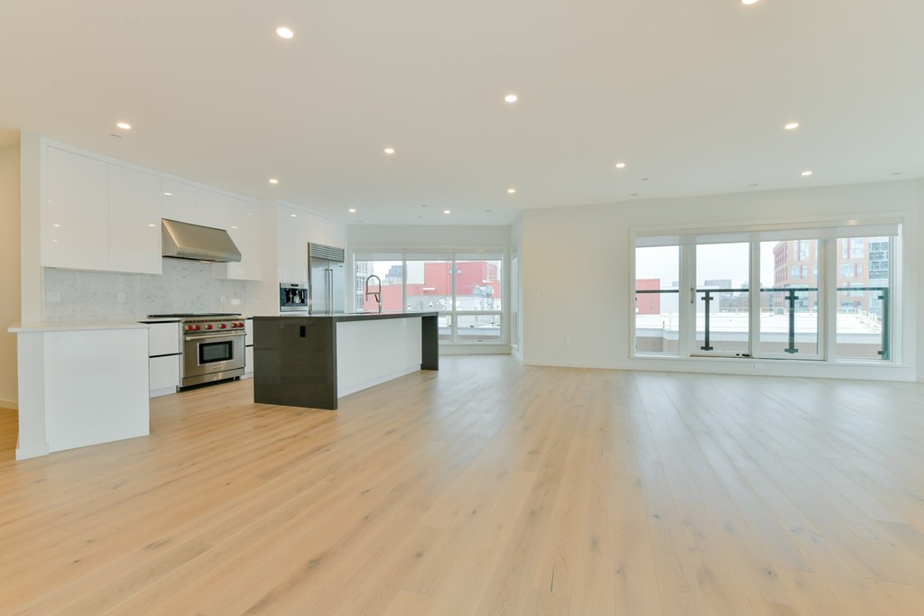 a view of kitchen with kitchen island and windows