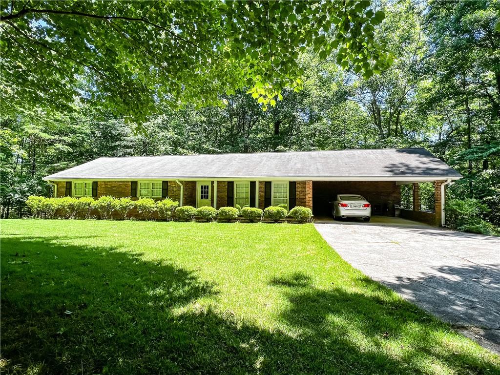 14875 South Thompson Road Alpharetta, GA 30004 - Photo 1 of 1 a front view of a house with a garden