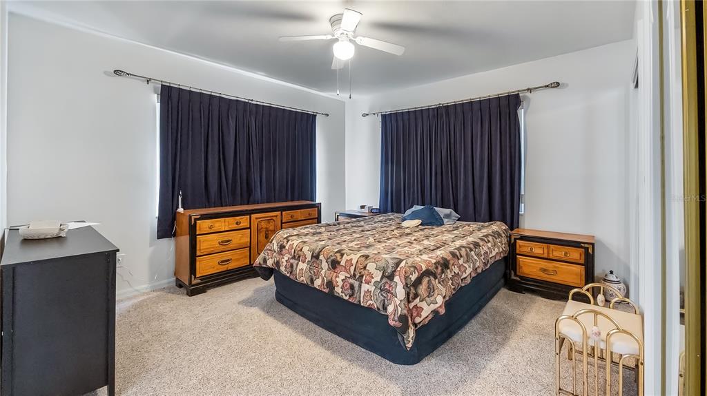 16317 Andrews Circle Cedar Key, FL 32625 - Photo 24 of 53 a bed sitting in a spacious bedroom next to a window