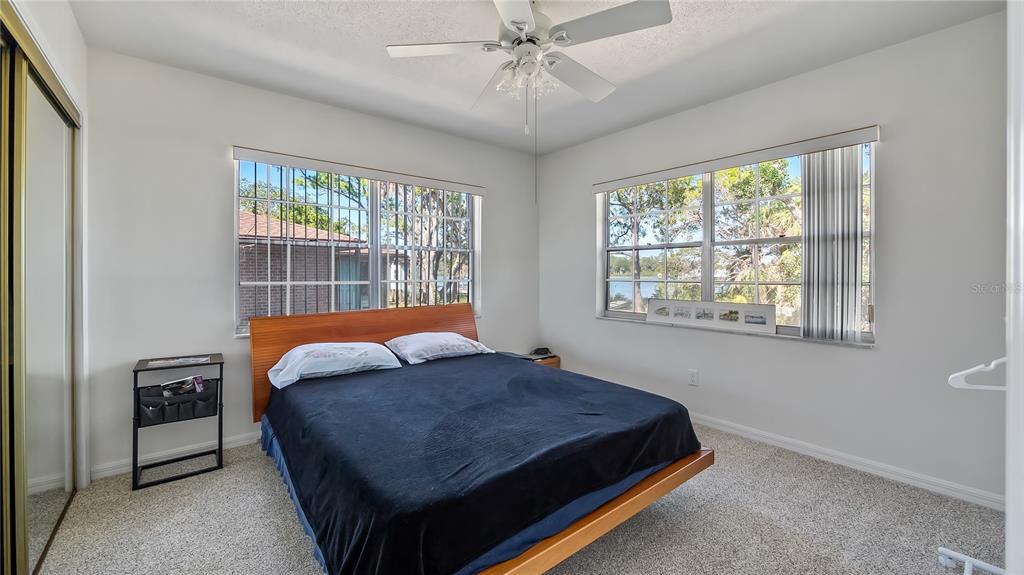16317 Andrews Circle Cedar Key, FL 32625 - Photo 30 of 53 a bedroom with a bed a dresser and a window