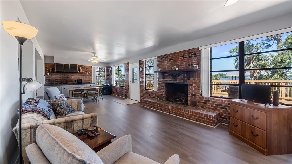 16317 Andrews Circle Cedar Key, FL 32625 - Photo 40 of 53 a living room with furniture a flat screen tv and a fireplace